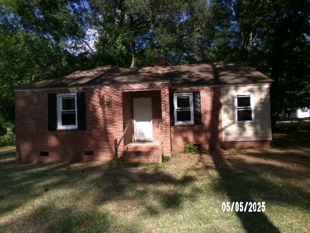 320 Camellia Ct, Camilla, GA 31730 - view of front of property with a chimney, a front yard, brick siding, and crawl space