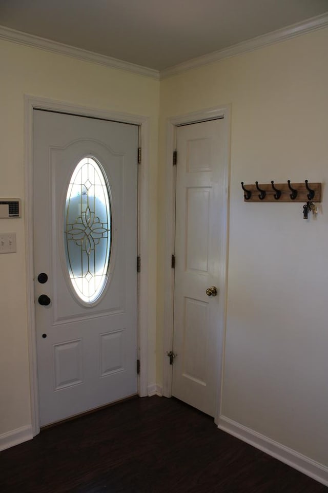 foyer entrance featuring baseboards, dark wood-style flooring, and crown molding