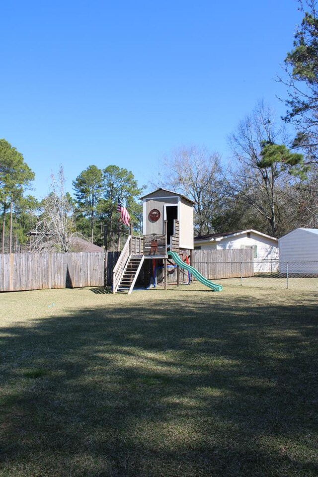 view of play area featuring a yard and fence