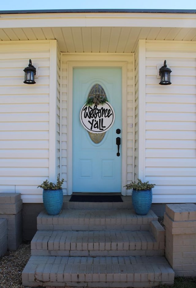 doorway to property with a garage