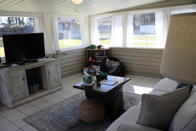 living room featuring light tile patterned floors, wooden ceiling, and a healthy amount of sunlight