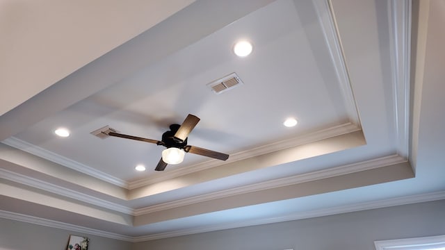 interior details with a tray ceiling, recessed lighting, visible vents, ornamental molding, and a ceiling fan