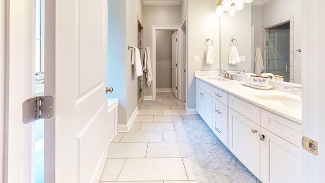 bathroom with double vanity, a stall shower, tile patterned flooring, and a sink