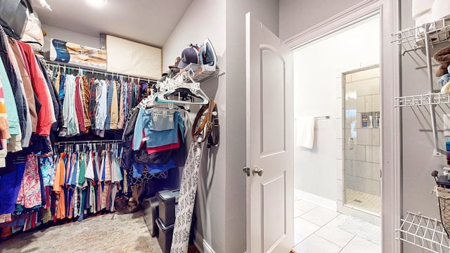 walk in closet with tile patterned floors