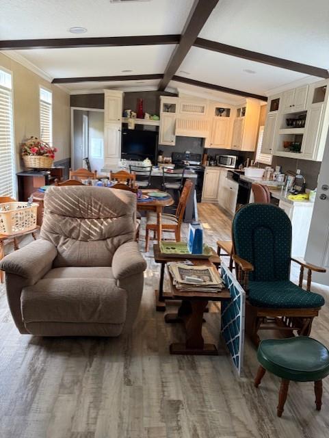 10806 Ga Highway 202, Ochlocknee, GA 31773 - living room with light wood finished floors, ornamental molding, and beamed ceiling
