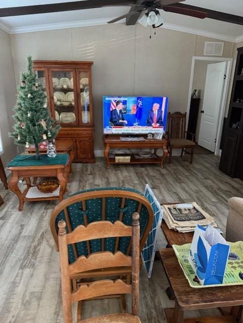 10806 Ga Highway 202, Ochlocknee, GA 31773 - living area featuring wood finished floors, crown molding, and a ceiling fan