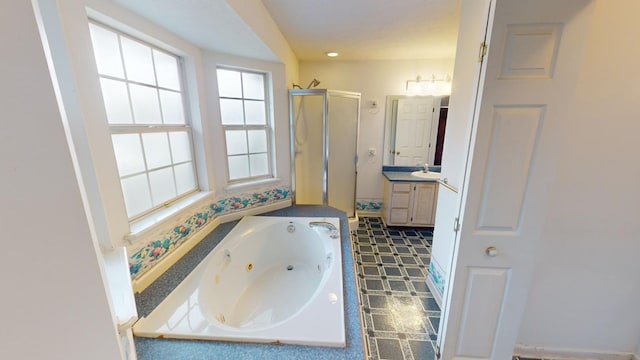 bathroom featuring vanity and shower with separate bathtub