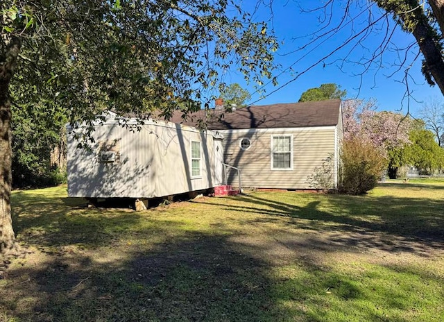 back of property featuring a lawn