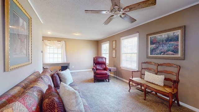 living area with carpet floors, ornamental molding, a textured ceiling, and ceiling fan