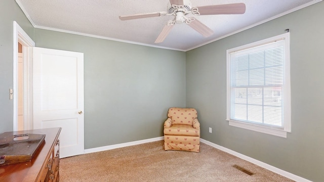 living area with a textured ceiling, light carpet, crown molding, and ceiling fan