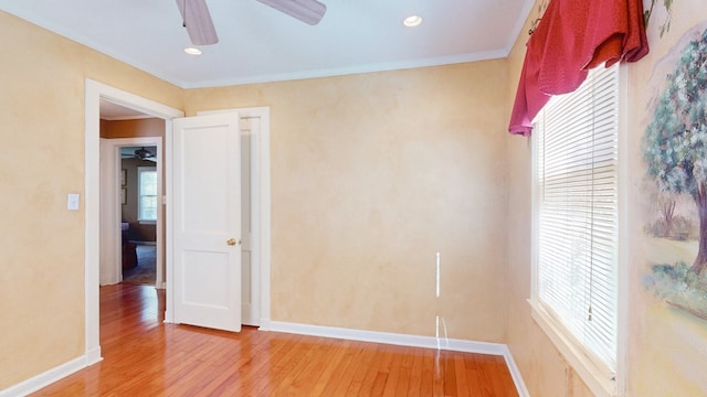 unfurnished room with hardwood / wood-style flooring, ceiling fan, and crown molding