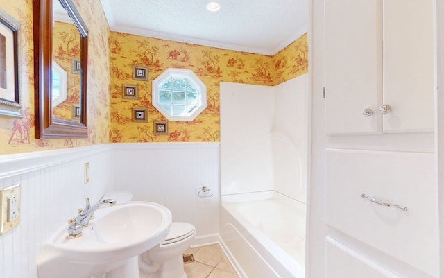 full bathroom featuring tub / shower combination, tile patterned floors, sink, toilet, and a textured ceiling