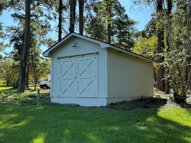 view of outdoor structure featuring a lawn