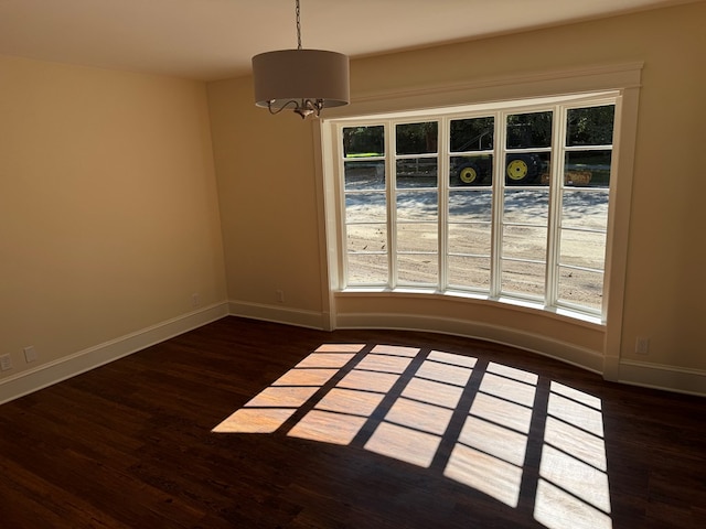 unfurnished room with dark wood-type flooring and a healthy amount of sunlight