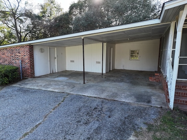 exterior space featuring an attached carport and driveway