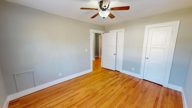 unfurnished bedroom featuring ceiling fan, light wood-style floors, and baseboards