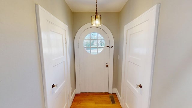 doorway with visible vents and light wood finished floors