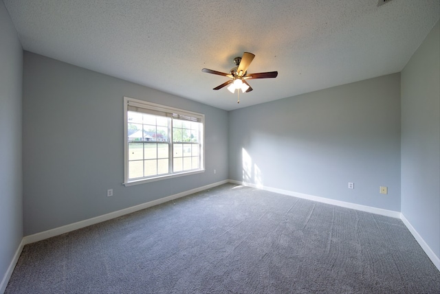 carpeted spare room with a textured ceiling, baseboards, and ceiling fan