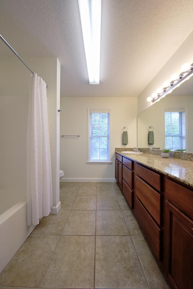 full bathroom featuring tile patterned floors, a healthy amount of sunlight, vanity, and a textured ceiling
