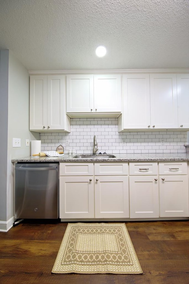 kitchen with a sink, white cabinets, dark wood-type flooring, and dishwasher