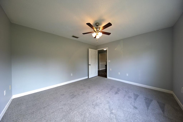 unfurnished bedroom with baseboards, a ceiling fan, visible vents, and carpet floors