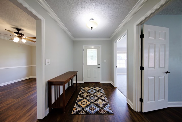 foyer entrance featuring ceiling fan, a textured ceiling, dark wood-type flooring, and ornamental molding