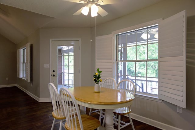 dining room featuring baseboards, lofted ceiling, ceiling fan, and dark wood-style floors