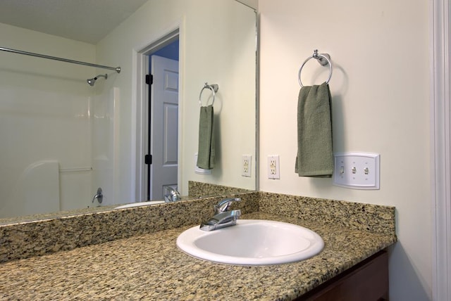 full bathroom featuring walk in shower and vanity