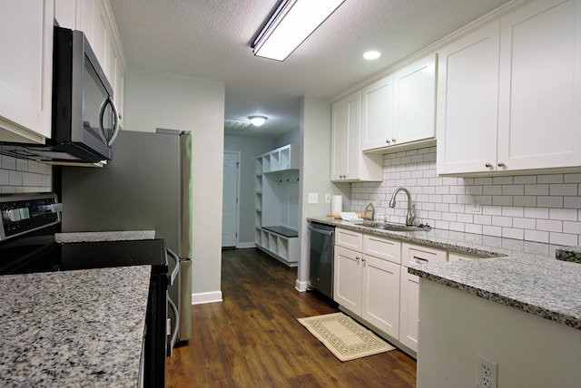 kitchen with a sink, stainless steel dishwasher, range with electric stovetop, and white cabinets