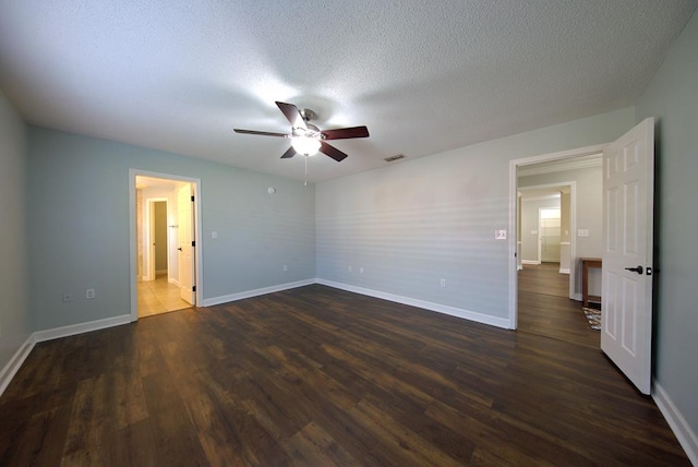 unfurnished bedroom with baseboards, dark wood-type flooring, and visible vents