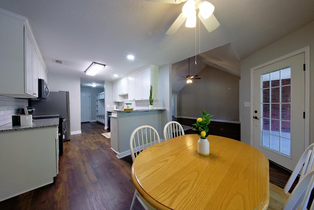 dining space featuring a ceiling fan, baseboards, dark wood-style flooring, lofted ceiling, and recessed lighting