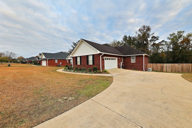 ranch-style home with fence, an attached garage, brick siding, driveway, and a front yard
