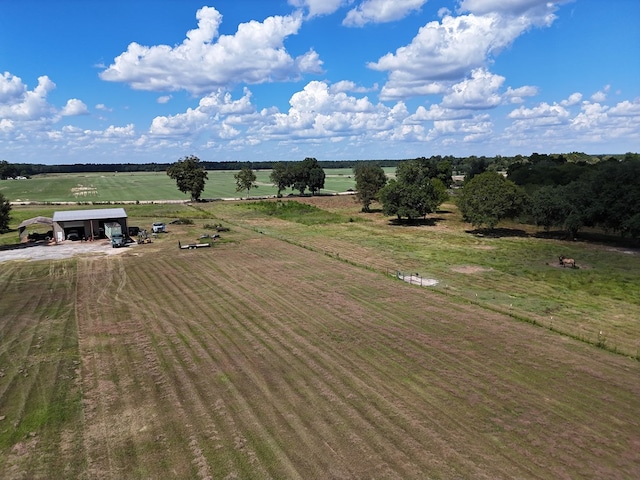 birds eye view of property with a rural view