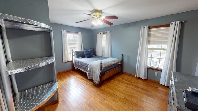 bedroom with ceiling fan and light wood-type flooring