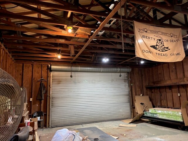 garage featuring wood walls