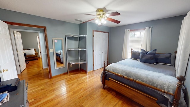 bedroom with light hardwood / wood-style floors and ceiling fan