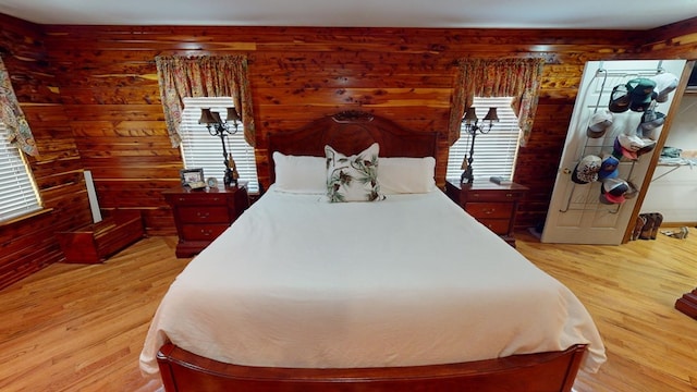 bedroom featuring wood walls and light wood-type flooring