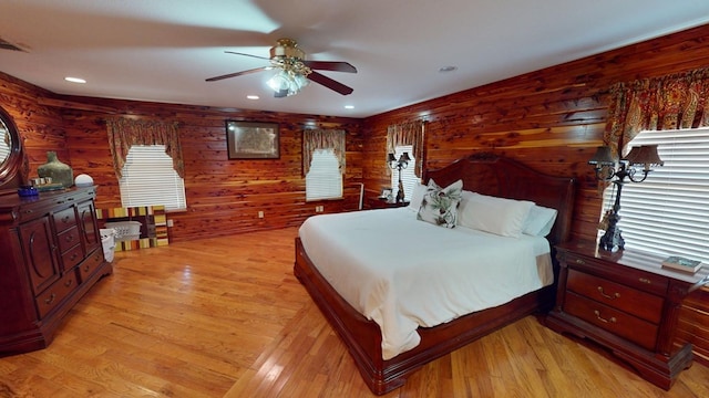 bedroom featuring multiple windows, ceiling fan, and light hardwood / wood-style floors