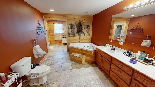 bathroom with vanity, a relaxing tiled tub, and toilet