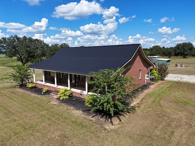 exterior space with a porch and a yard