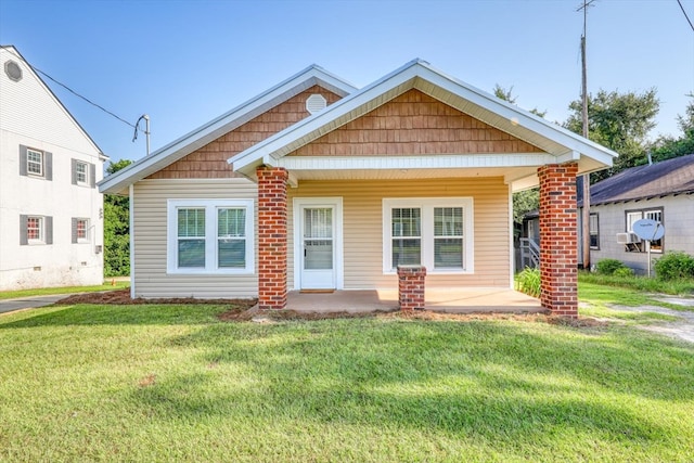 bungalow-style home featuring a front yard and a porch