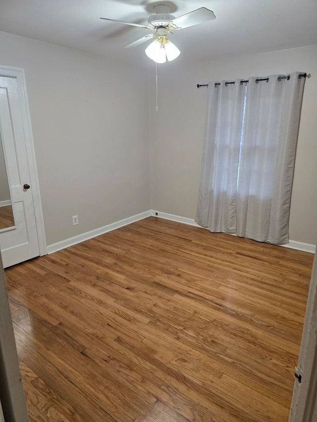 empty room featuring hardwood / wood-style floors and ceiling fan