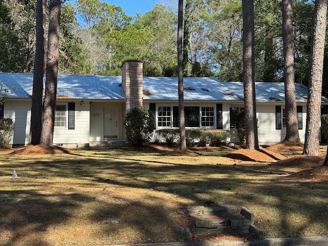 ranch-style home featuring a front yard