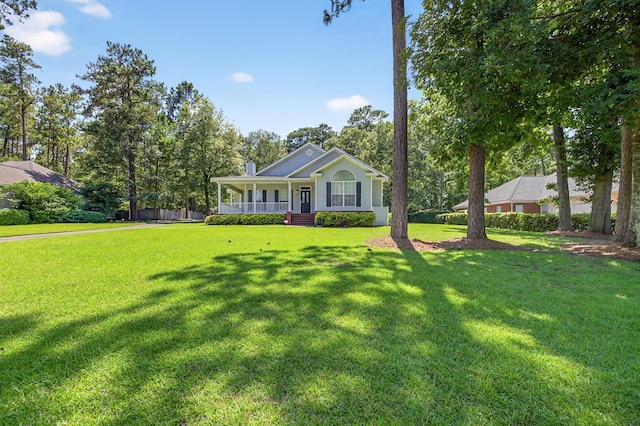 71 Buckfast Ct, Thomasville, GA 31792 - view of front facade with a porch, a front lawn, and a chimney