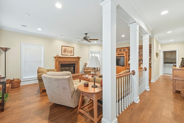 71 Buckfast Ct, Thomasville, GA 31792 - living room with decorative columns, light wood finished floors, a fireplace, a ceiling fan, and recessed lighting
