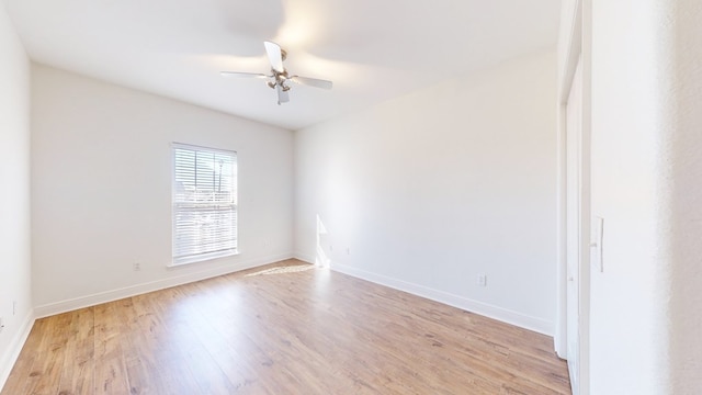 spare room with ceiling fan and light wood-type flooring