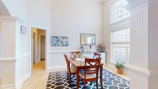 dining room featuring a high ceiling and light tile patterned flooring