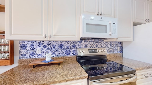 kitchen with white cabinets, electric range, and decorative backsplash