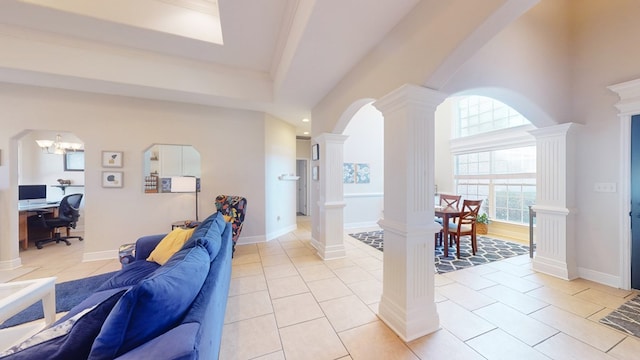 living room featuring ornate columns and light tile patterned floors