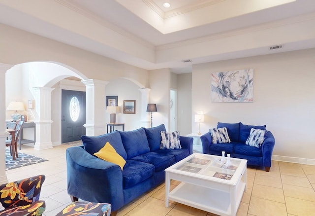 tiled living room with crown molding, a tray ceiling, and ornate columns